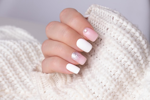 Female hands with pink and silver manicure nails