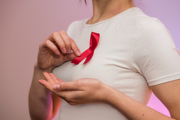 Female hands with red ribbon. Social advertising. Healthcare concept