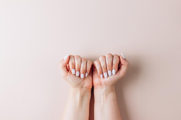 Female hands with a trendy Glitter Reverse French Manicure