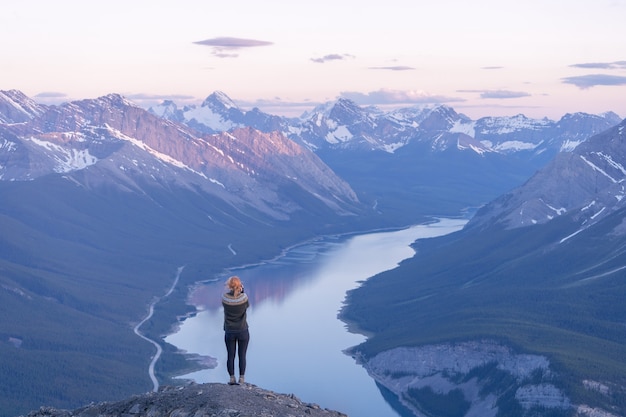 Female hiker enjoying the view on the alpine valley during sunset rimwall summitcanada