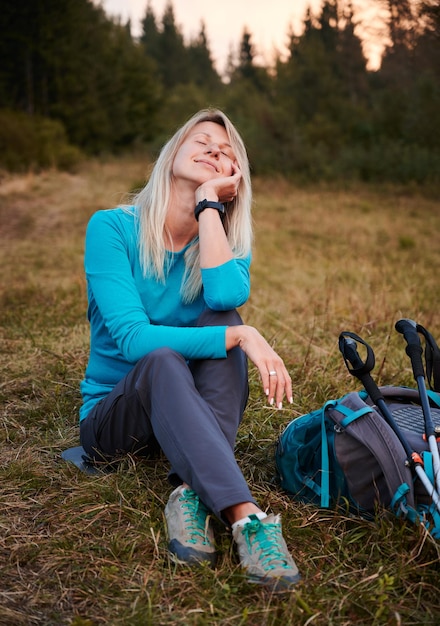 Female hiker having rest outdoors while hike