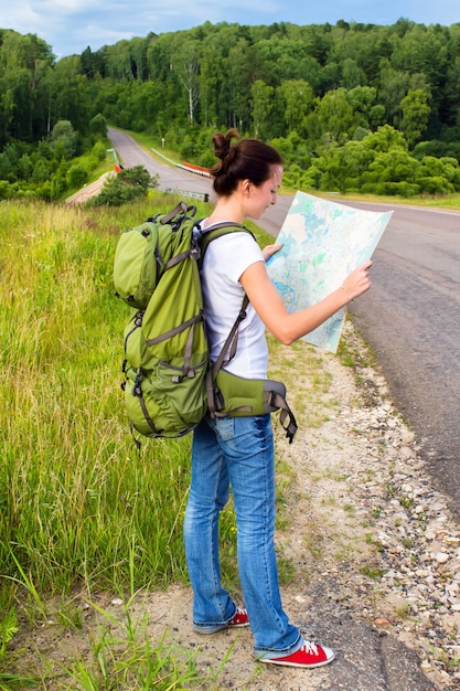 Female hiker reading map