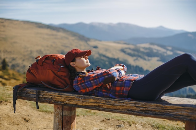 Female hiker resting on top of the mountain