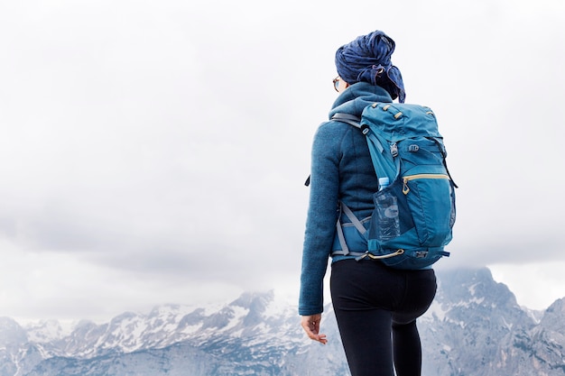 Female hiker standing on the top of the mountain with beatufil panorama below