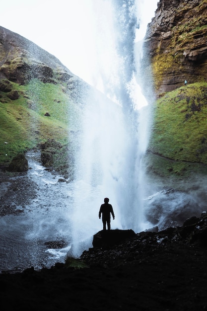 Female hiker with a view of Kvernufoss waterfall in South Iceland