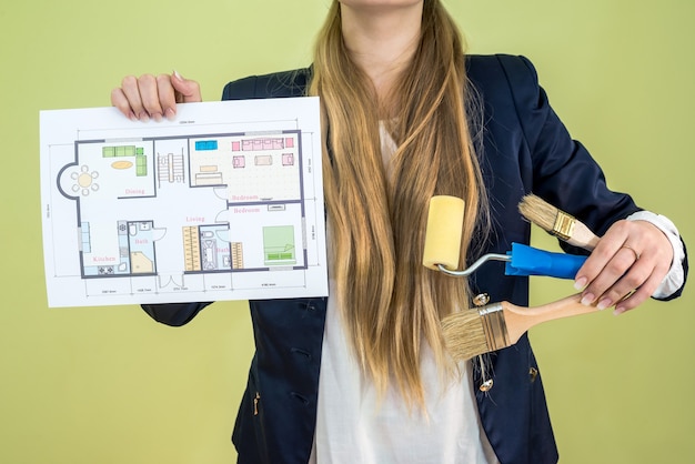 Photo female holding house plan and work tools