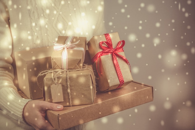 Female holding stack of christmas presents