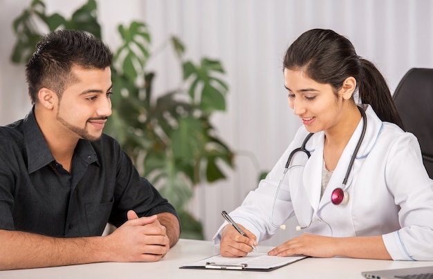 Female Indian physician communication with male patients