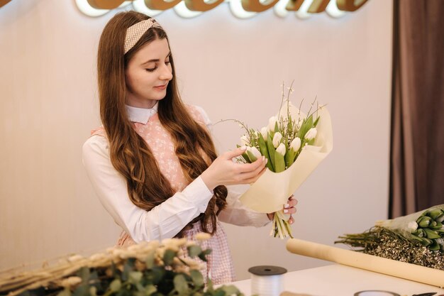 Female make spring bouquet gardeners in the flower shop make bouquet lifestyle flower shop beautiful