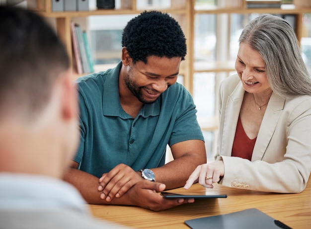 Female manager boss or leader meeting with an employee with a digital tablet Intern project supervisor discuss online work or report in the boardroom Businessman and lady talk strategy development