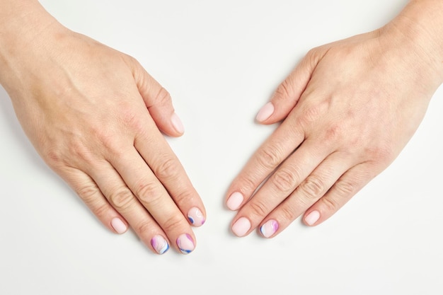 female manicure on a white background. nail. Women's hands with a beautiful manicure.