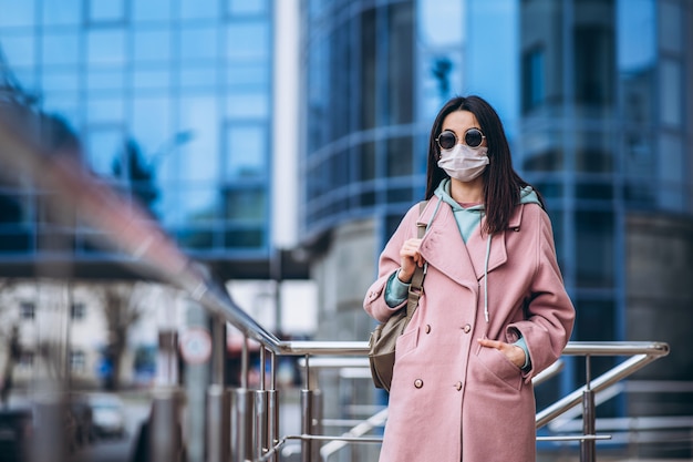 Female in medical mask outdoors in the empty city. Health protection and prevention of virus outbreak, coronavirus, COVID-19, epidemic, pandemic, infectious diseases, quarantine concept.