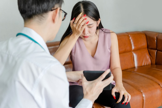 A female mental patient talking to a young doctor