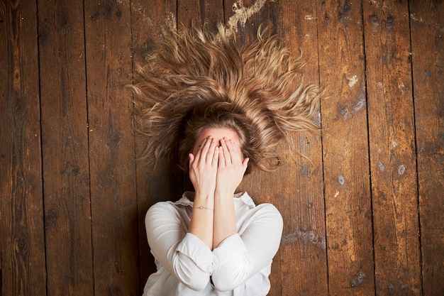 Female model laying down on wood floor