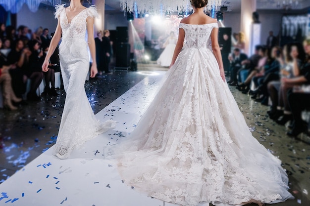 Female models walk the runway in beautiful stylish white wedding dresses during a Fashion Show