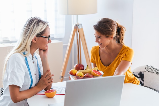 Female nutritionist giving consultation to patient