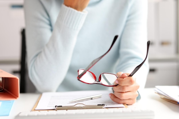 Female office manager working with documents at workplace