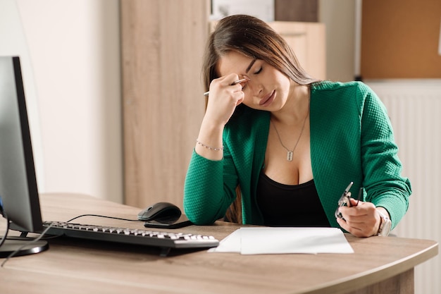 Female office worker or secretary is working on the desk in the office