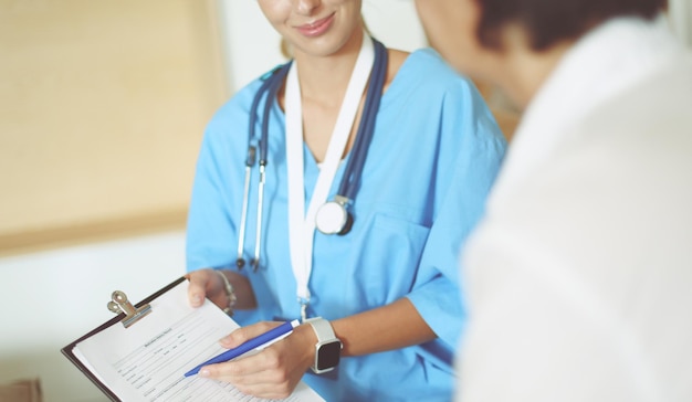 Female patient and doctor have consultation in hospital room