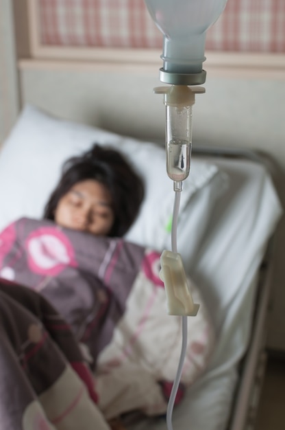 Female patient resting on hospital bed