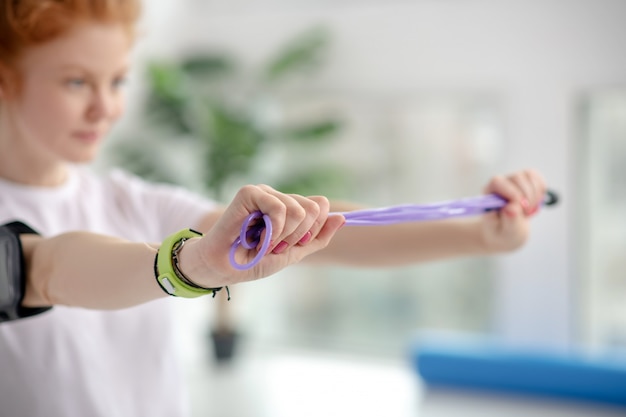 Female patient stretching jump rope with hands