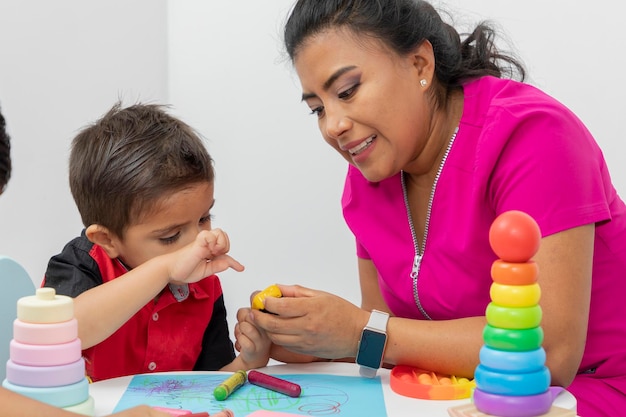 Female pediatrician doctor checking a child with an oximeter in her medical office