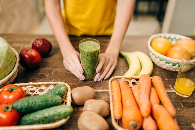 Female person hands with cocktail of fruit and vegetables