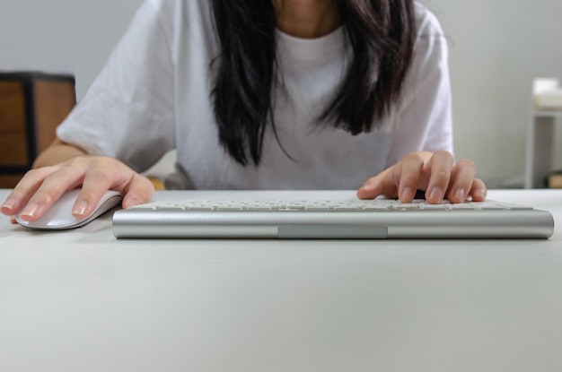 Female person holding mouse and keyboard computer Technology internet information browsing online social media and network concept