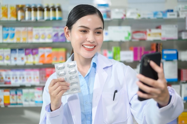 Female pharmacist counseling customer via video call in a modern pharmacy drugstore