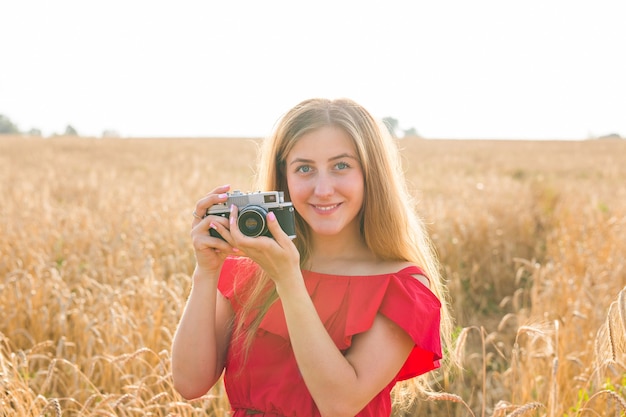 Female photographer in the field with a camera taking pictures