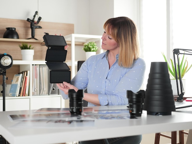 Female photographer holding solar power bank