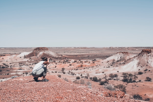 A female photographer and traveler is taking shots in a spectacular desertic and secluded location