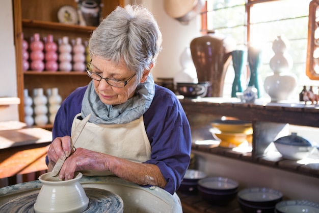 Female potter making pot