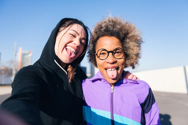 Female runner friends taking selfie and having fun