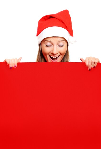 a female Santa holding a red board