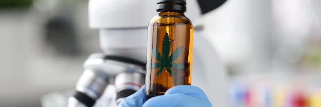 Female scientist in laboratory testing cbd oil extracted from marijuana plant healthcare