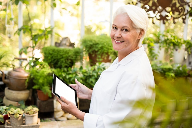 Female scientist using digital tablet at greenhouse