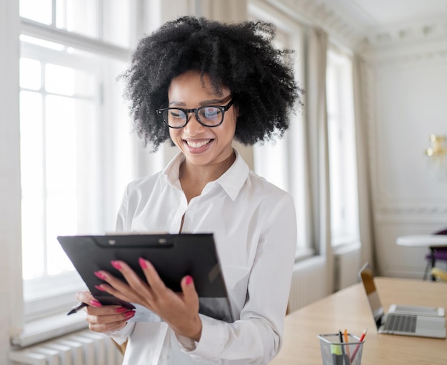 A female secretary works online in the office using a tablet coworking space