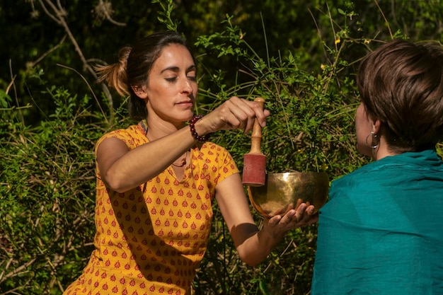 Female sound therapist with a patient in a natural setting Concept Healing reflections