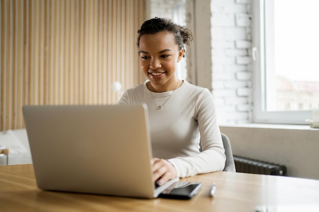 Female startup assistant online project Uses laptop to print a message The employee monthly report