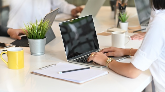 Female startup working on her project with laptop in meeting room.