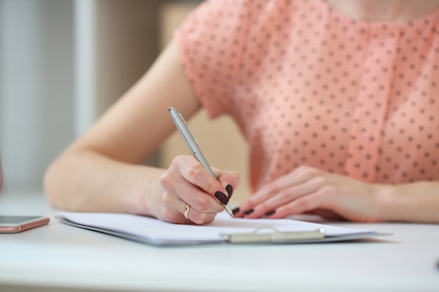 Female student doing homework .With depth of field image