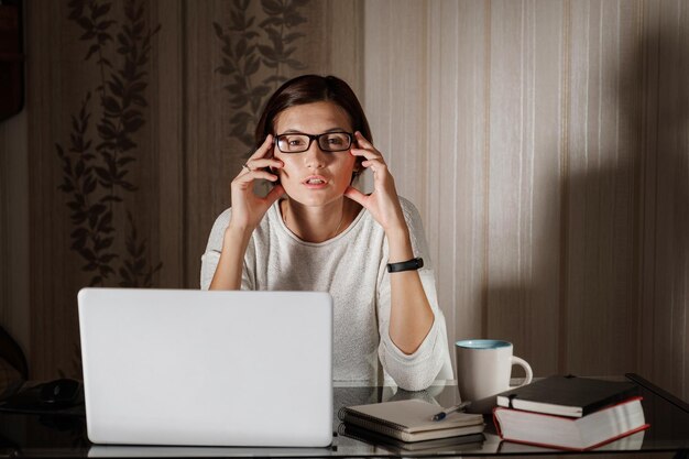 Female student freelancer working at home on a task