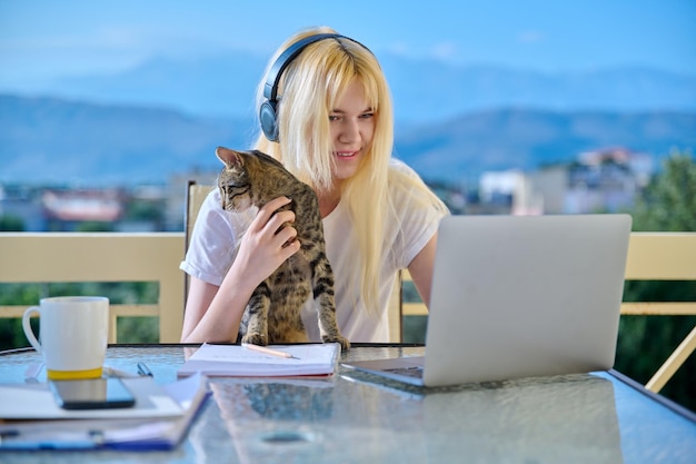 Female student studies at home online using a laptop