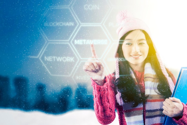 Female student touch metaverse word under snowfall