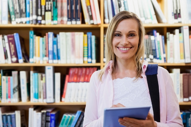 Female student using tablet in library at the university