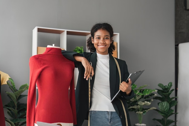 Female stylist Successful Fashion Business Portrait of Smiling Black Designer stylish standing and working at fashion studio Portrait of fashion designer in office