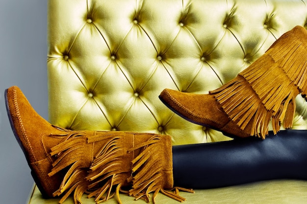 Female suede brown boots with fringe