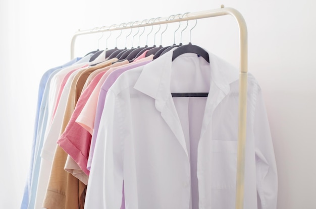 Female summer wardrobe in white room