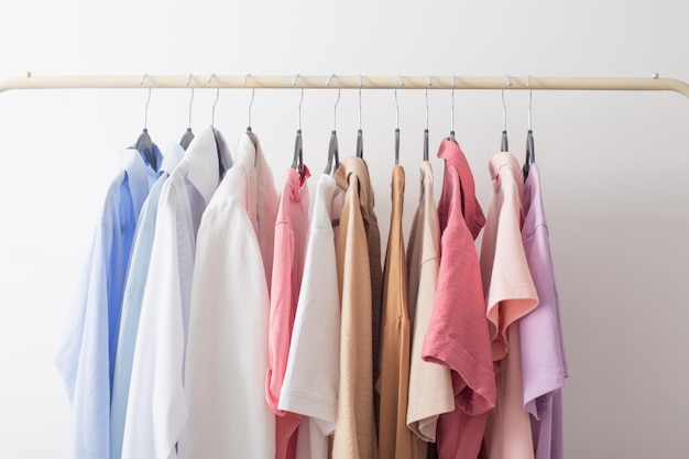 Female summer wardrobe in white room